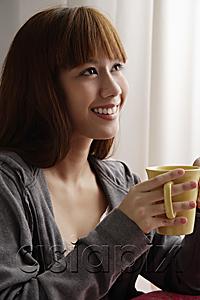 AsiaPix - Asian girl holding coffee mug