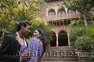 Asia Images Group - young couple in front of traditional Indian building, gazing at each other