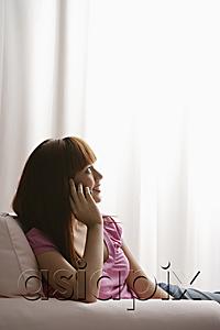 AsiaPix - Asian girl looking out window while talking on phone