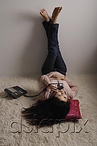 AsiaPix - Chinese woman laying on floor, talking on phone