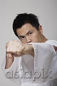AsiaPix - Head shot of Chinese man punching, martial arts