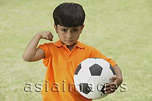 Asia Images Group - little boy showing muscle, holding soccer ball