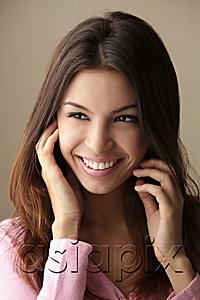 AsiaPix - head shot of young woman with hands on her face