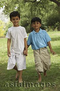 Asia Images Group - two little boys holding hands in a park