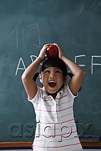 AsiaPix - young girl holding apple on top of her head and laughing