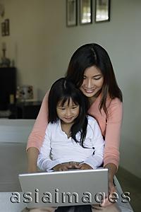 Asia Images Group - Mother and daughter working at laptop computer