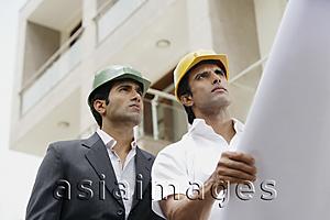 Asia Images Group - contractors or architects with blueprints