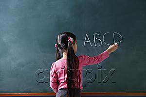 AsiaPix - rear view of young girl writing on chalk board