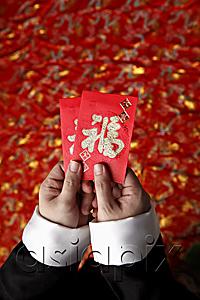 AsiaPix - Cropped shot of hands holding red envelopes