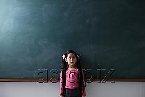 AsiaPix - Young girl with pony tails standing in front of a chalk board