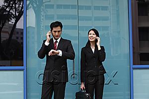 AsiaPix - Man and woman wearing suits and talking on phones