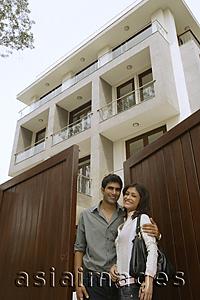 Asia Images Group - Young couple in front of home