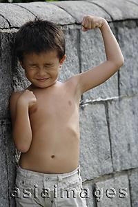 Asia Images Group - Boy flexing his muscles