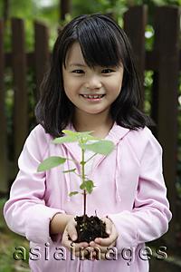 Asia Images Group - Girl holding plant in soil