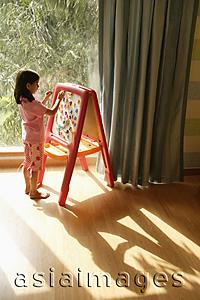 Asia Images Group - little girl at easel