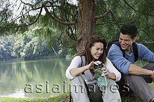 Asia Images Group - couple resting under tree