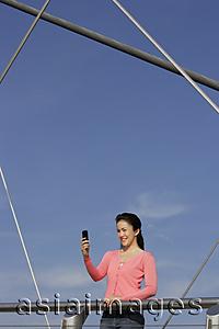Asia Images Group - Young woman with cell phone