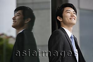 Asia Images Group - Profile and reflection of businessman smiling