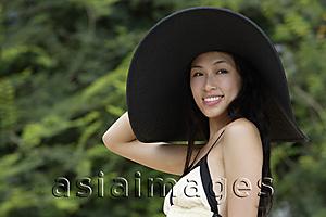 Asia Images Group - Young woman wearing big black hat
