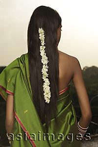 Asia Images Group - woman wearing sari with strand of jasmine blossom in her hair