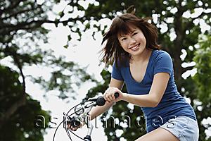 Asia Images Group - Young woman riding bike