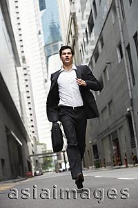 Asia Images Group - businessman running down street