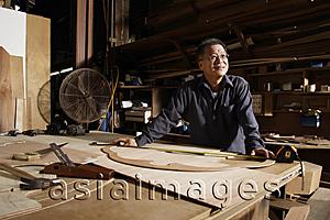 Asia Images Group - Mature man working in his wood shop.