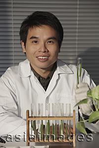 Asia Images Group - Scientist holding a test tube.