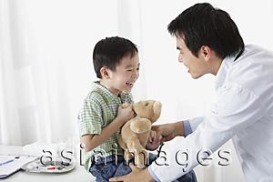 Asia Images Group - Doctor laughing with young boy