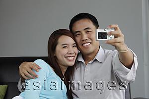 Asia Images Group - Young couple taking a photograph of each other