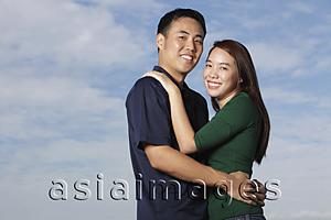 Asia Images Group - Young couple hugging and smiling