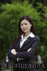 Asia Images Group - Chinese woman looking at camera with arms folded