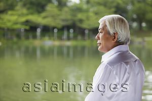 Asia Images Group - Profile of older man looking at lake