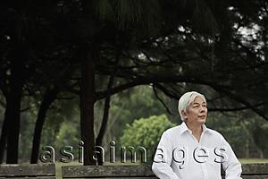 Asia Images Group - Older man with white hair sitting in park