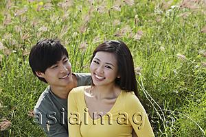 Asia Images Group - Young couple sitting on grass smiling together