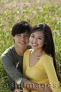Asia Images Group - Young couple holding each other in a field