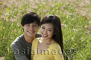 Asia Images Group - smiling couple outside in grassy field