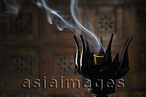 Asia Images Group - Incense burning in lotus incense burner