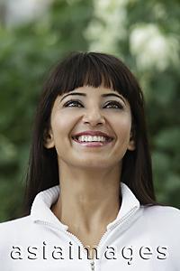 Asia Images Group - Head shot of woman looking up and smiling