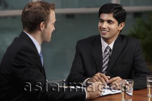 Asia Images Group - Caucasian man talking to Indian man at table