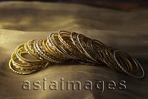 Asia Images Group - Gold bangles on gold sari