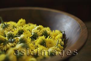 Asia Images Group - yellow chrysanthemum flowers in wooden bowl