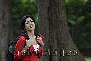 Asia Images Group - Mid shot of young woman wearing back pack and smiling