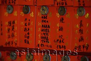 Asia Images Group - Different fortunes written on red paper at a Buddhist Temple