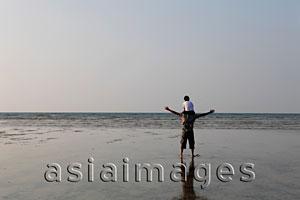 Asia Images Group - Son sitting on father's shoulders looking at the sea