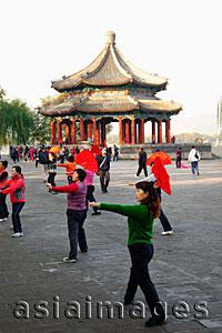 Asia Images Group - China,Beijing,Summer Palace Park,Woman Exercising with fans