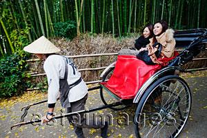 Asia Images Group - Two women riding in a rickshaw, Japan
