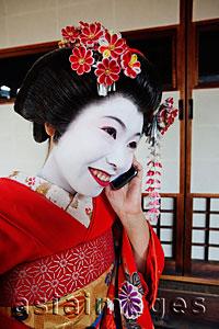 Asia Images Group - Geisha talking on phone and smiling