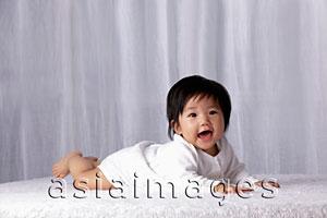 Asia Images Group - Chinese baby on tummy smiling