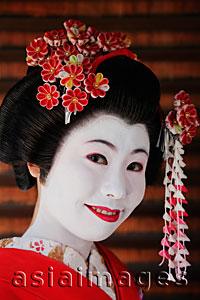 Asia Images Group - Japanese woman in traditional make up with flowers in her hair